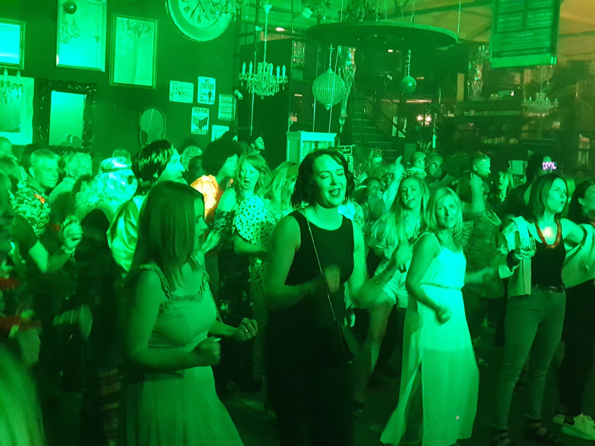 Crowd dancing at a live music event at H@ME & EAT